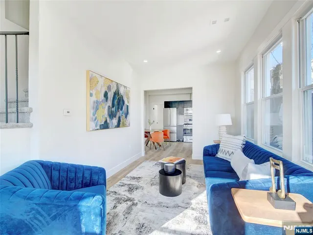 a living room with furniture a rug and a window