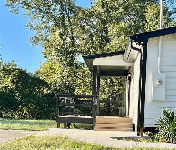 a view of a door of the house and a yard