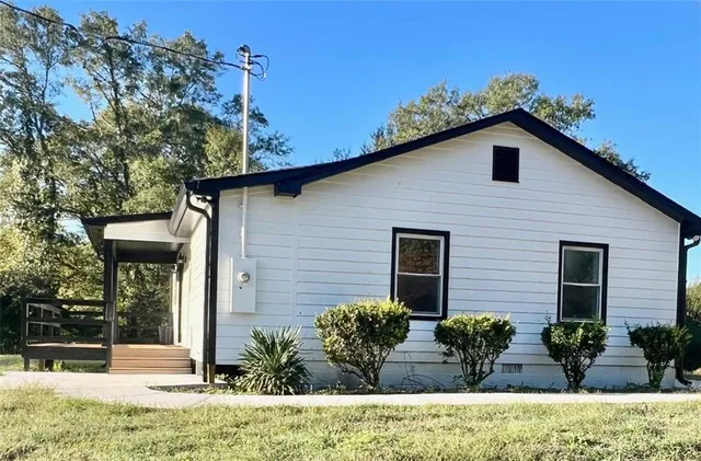a view of a house with potted plants and a table