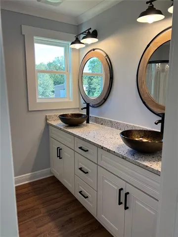 a bathroom with a granite countertop toilet a sink and a mirror