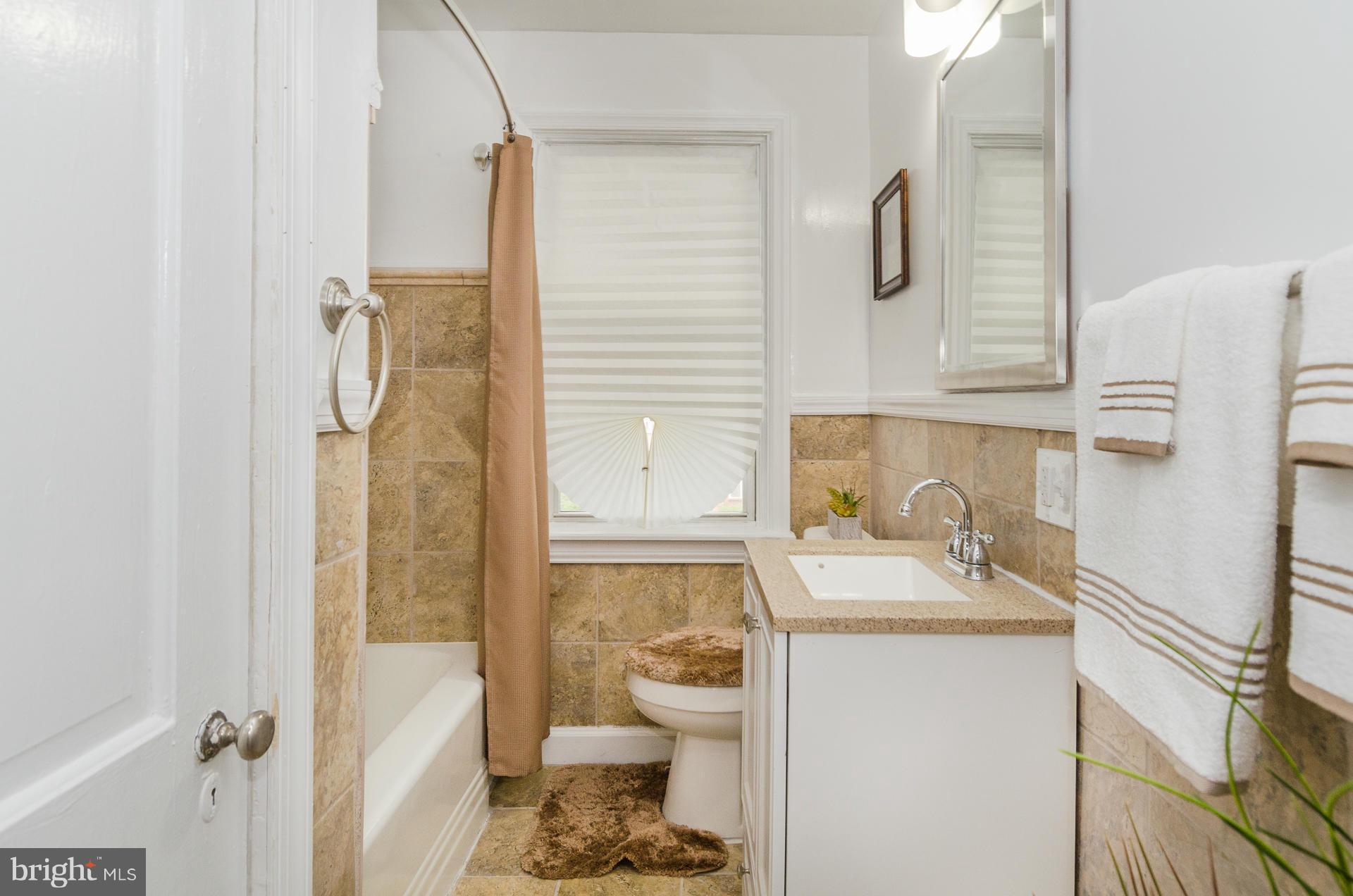 4645 Rokeby Road Baltimore, MD 21229 - Photo 14 of 30 a bathroom with a sink toilet and shower