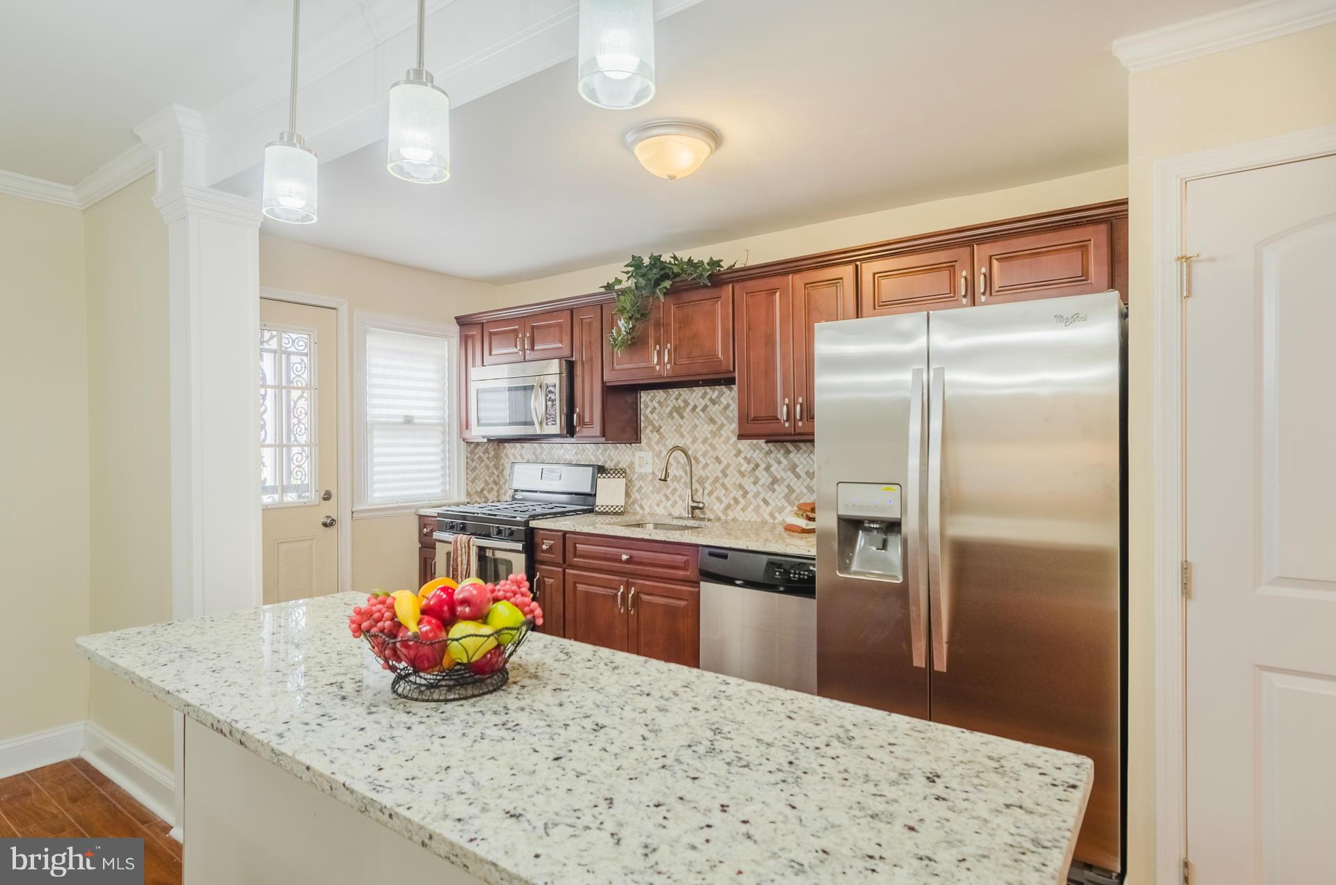 4645 Rokeby Road Baltimore, MD 21229 - Photo 8 of 30 a kitchen with stainless steel appliances granite countertop a sink a stove and a refrigerator