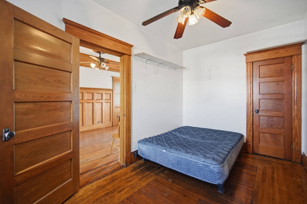 99-101 High Street Holyoke, MA 01040 - Photo 11 of 27 a living room with wooden floor and ceiling fan