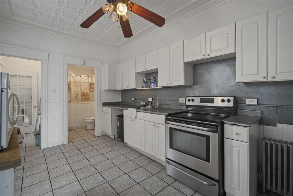 99-101 High Street Holyoke, MA 01040 - Photo 13 of 27 a kitchen with stainless steel appliances granite countertop a stove a sink and a refrigerator