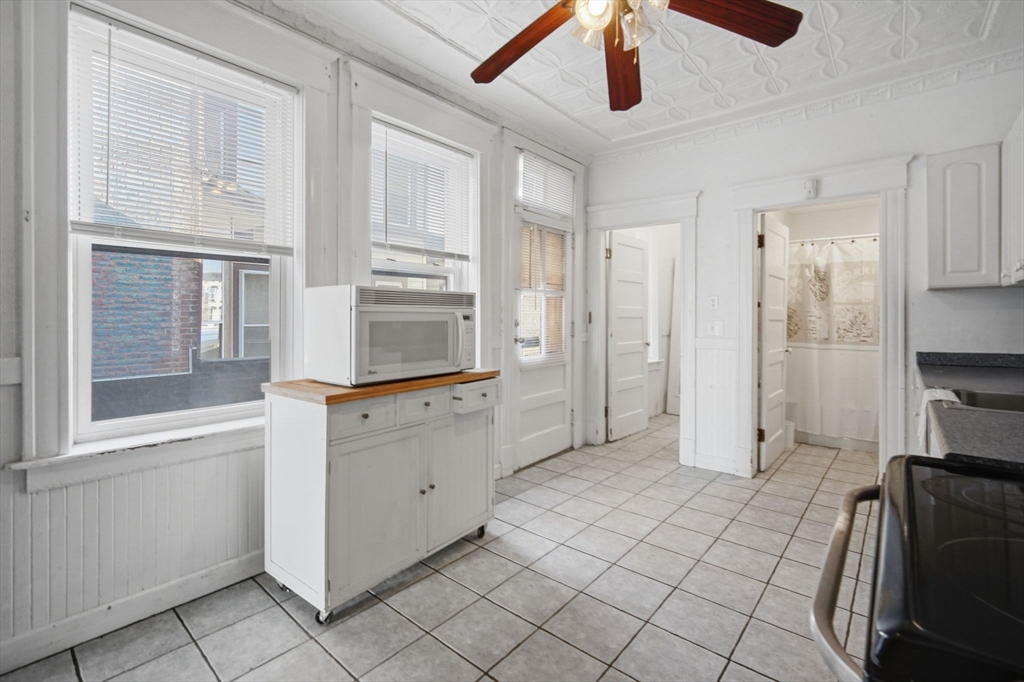 99-101 High Street Holyoke, MA 01040 - Photo 14 of 27 a kitchen with white cabinets and appliances
