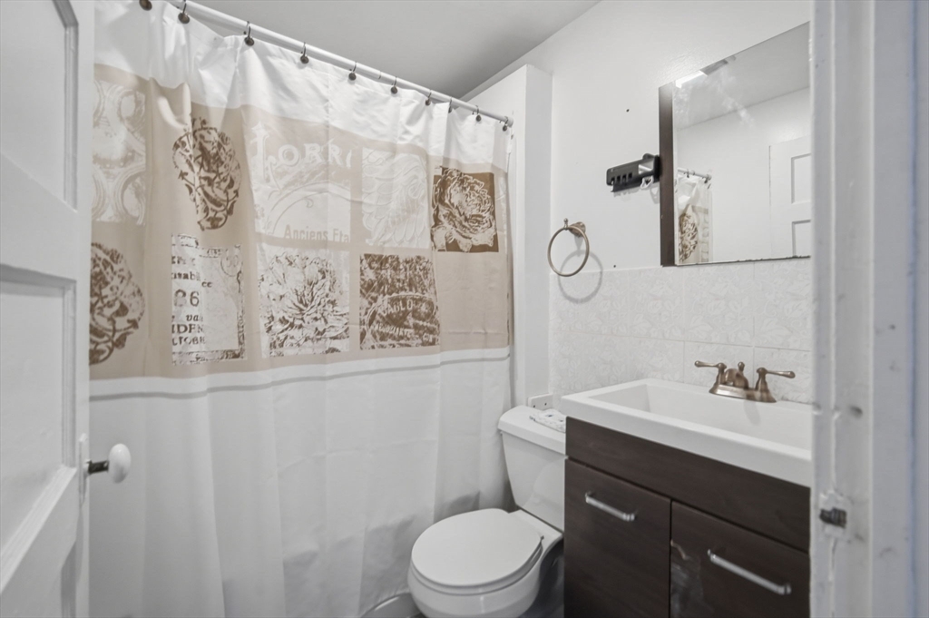 99-101 High Street Holyoke, MA 01040 - Photo 16 of 27 a bathroom with a toilet sink and shower