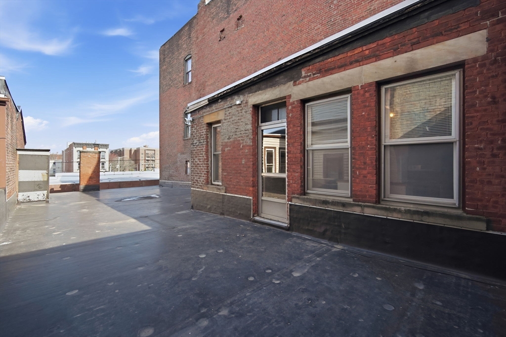 99-101 High Street Holyoke, MA 01040 - Photo 17 of 27 a view of a porch with a table and chairs