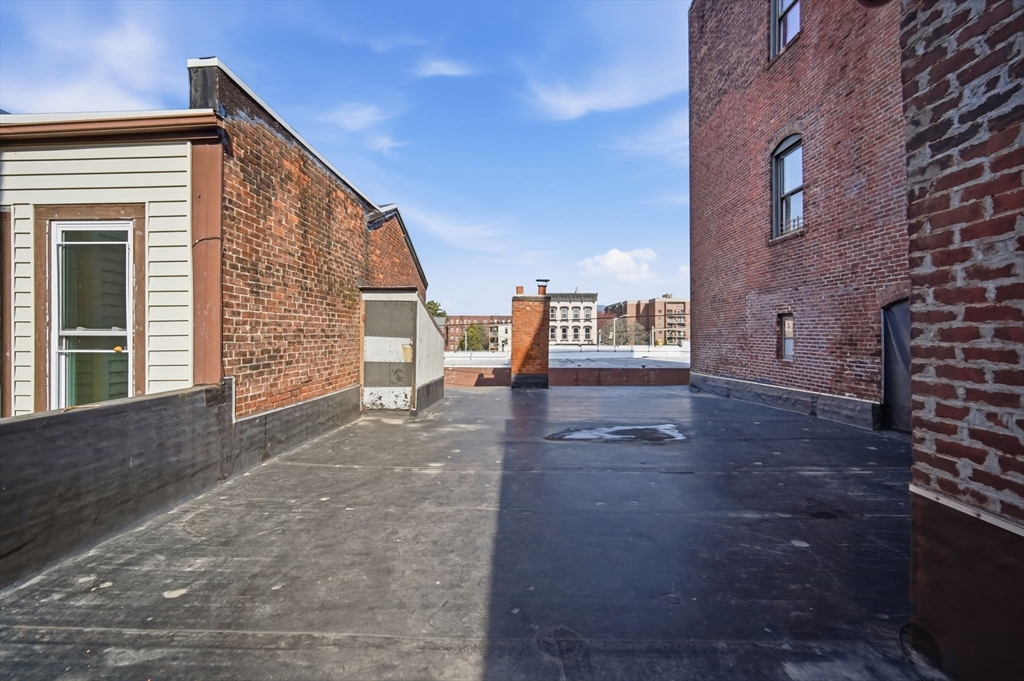 99-101 High Street Holyoke, MA 01040 - Photo 18 of 27 a view of a house with barbeque and bench