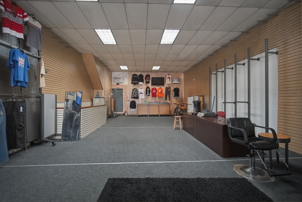 99-101 High Street Holyoke, MA 01040 - Photo 6 of 27 a living room filled with furniture and a chandelier