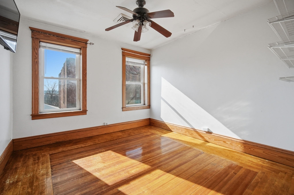 99-101 High Street Holyoke, MA 01040 - Photo 10 of 27 a view of an empty room with window and wooden floor