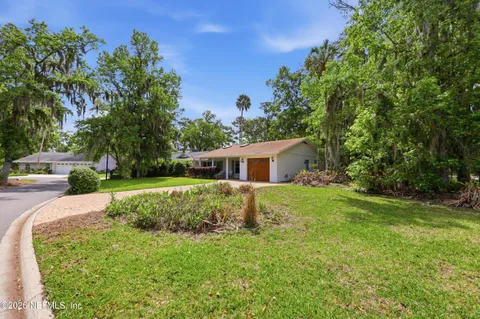 a view of a house with yard and a garden