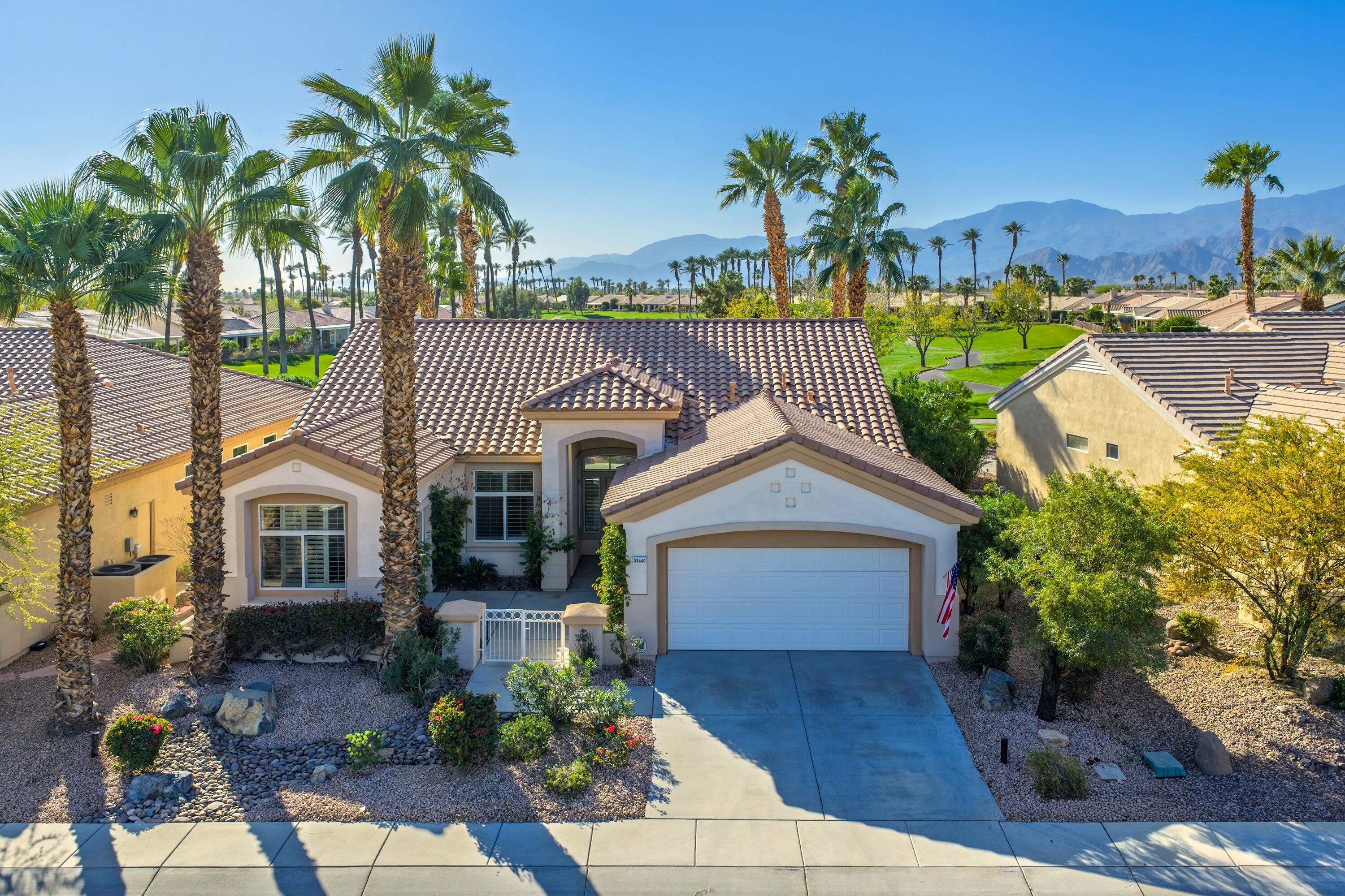 35440 Moorbrook Road Palm Desert, CA 92211 - Photo 2 of 32 a front view of a house with garden