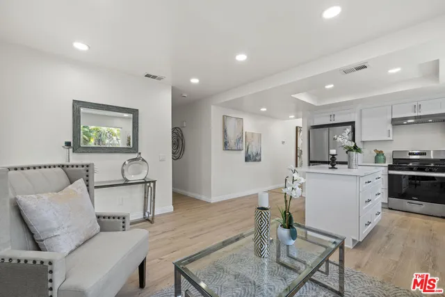 a living room with furniture and kitchen view
