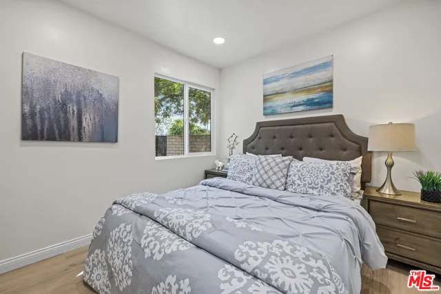 a bedroom with a bed and a painting on the wall