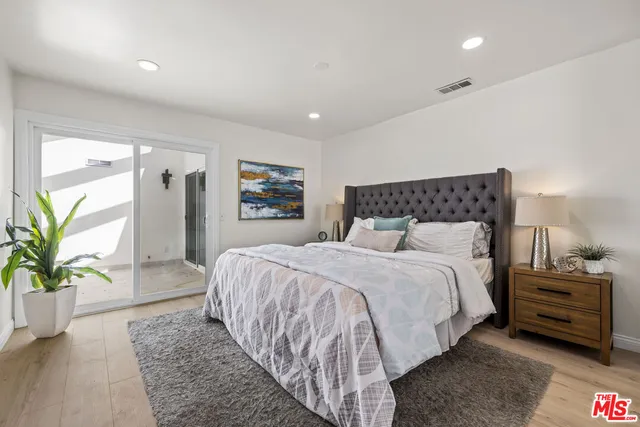 a bedroom with a bed and a couch