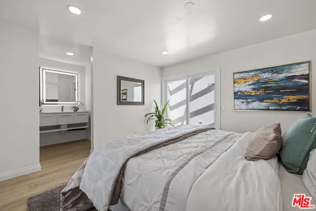 a bedroom with a bed and a view of kitchen