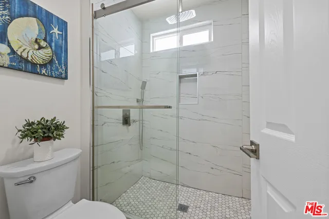 a bathroom with a toilet sink and shower