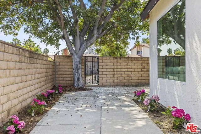 a view of a house with a tree in the background