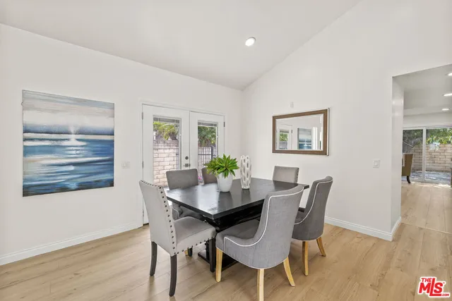 a dining room with furniture and wooden floor
