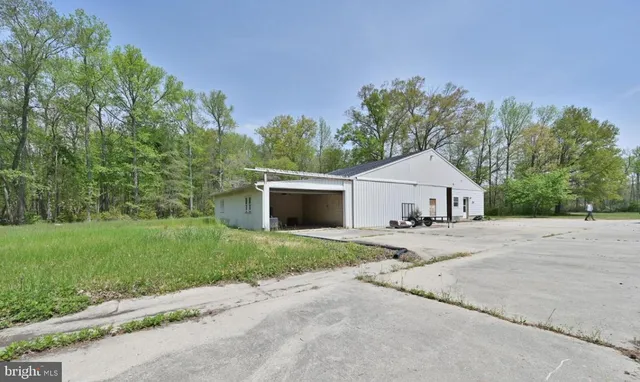 a view of a house with a yard and garage