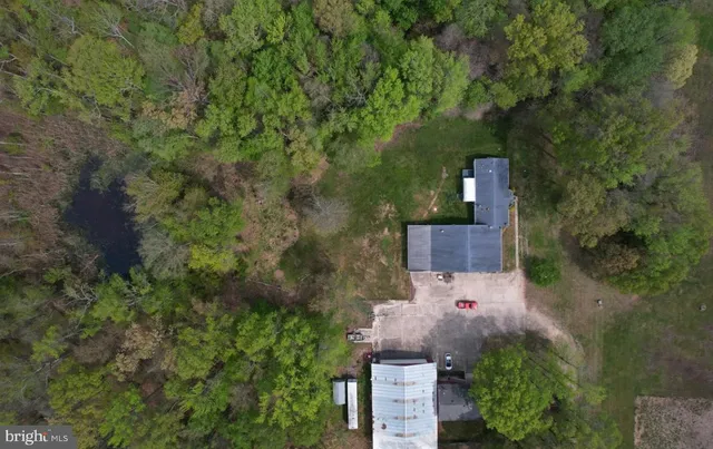 an aerial view of a house with a yard and garden