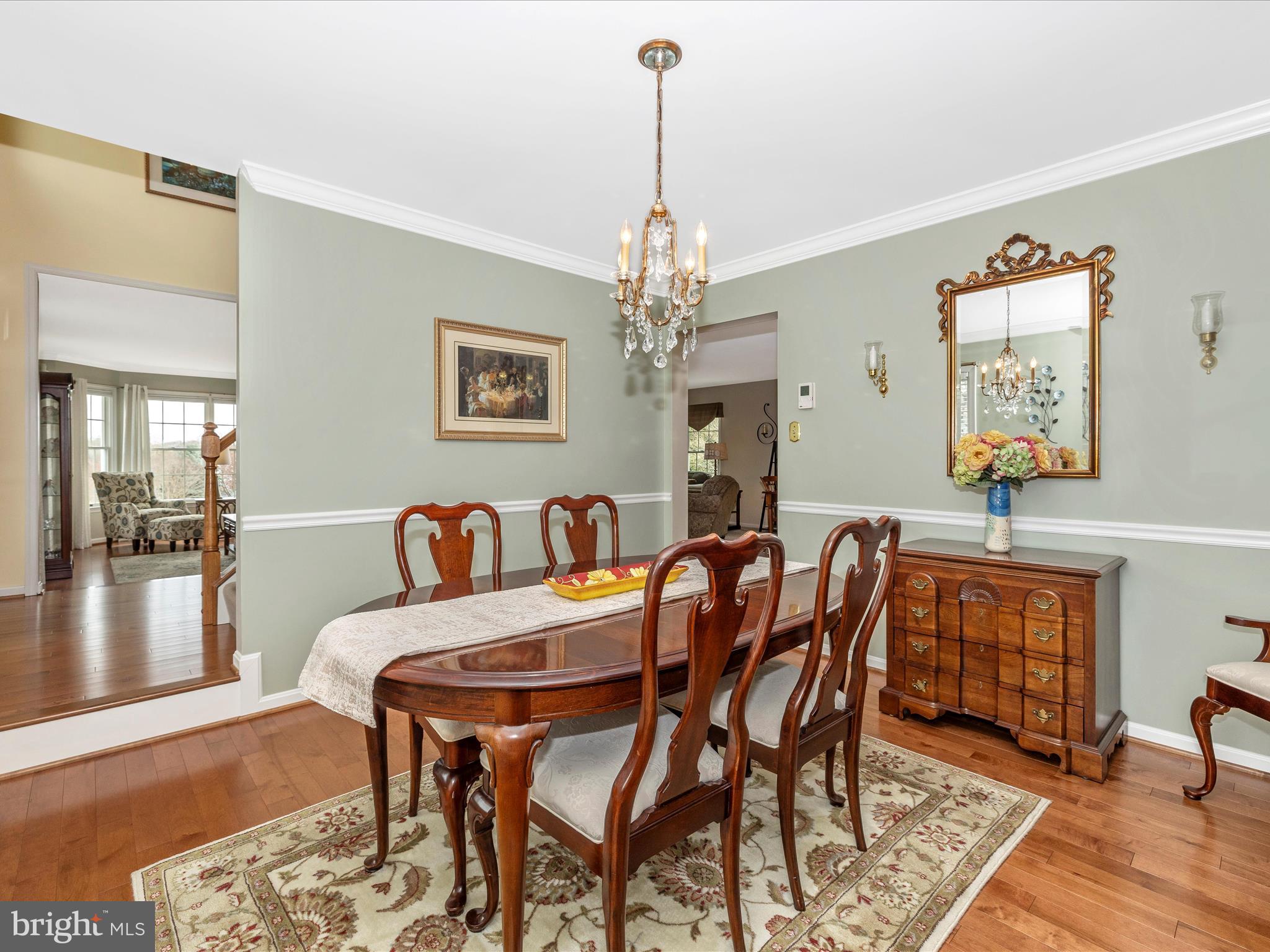 4945 Jalmia Road Mount Airy, MD 21771 - Photo 7 of 45 a dining room with furniture wooden floor a rug and a chandelier