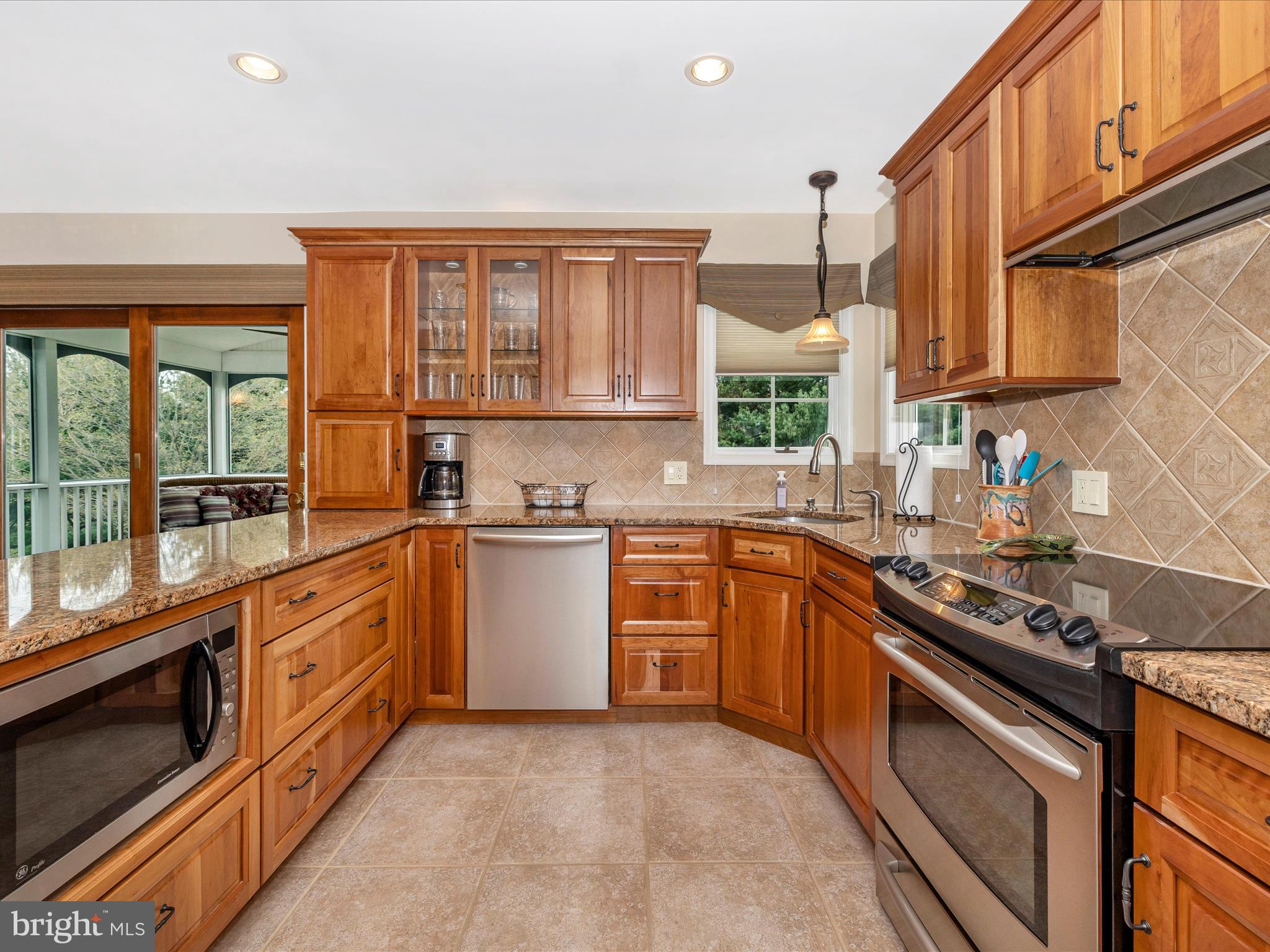 4945 Jalmia Road Mount Airy, MD 21771 - Photo 9 of 45 a kitchen with stainless steel appliances granite countertop a stove a sink and a microwave