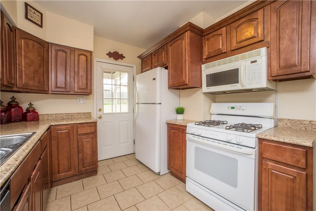 128 Marham Road Homestead, PA 15120 - Photo 17 of 24 Another view of the kitchen with the door leading out back.