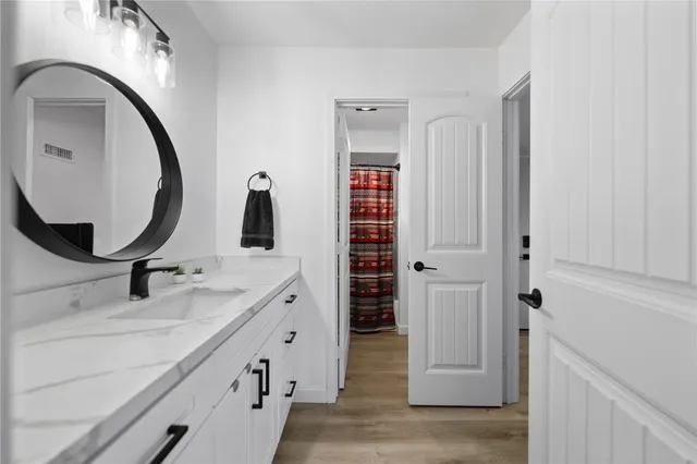 a bathroom with a double vanity sink and a mirror