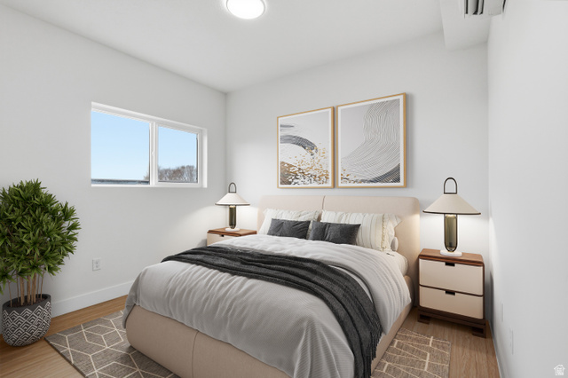 2085 North Main Street, Unit 216 Sunset, UT 84015 - Photo 5 of 12 Bright bedroom featuring wood-finish flooring, white walls, and a large window