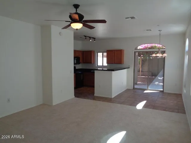 a kitchen with stainless steel appliances granite countertop a sink a stove and a refrigerator