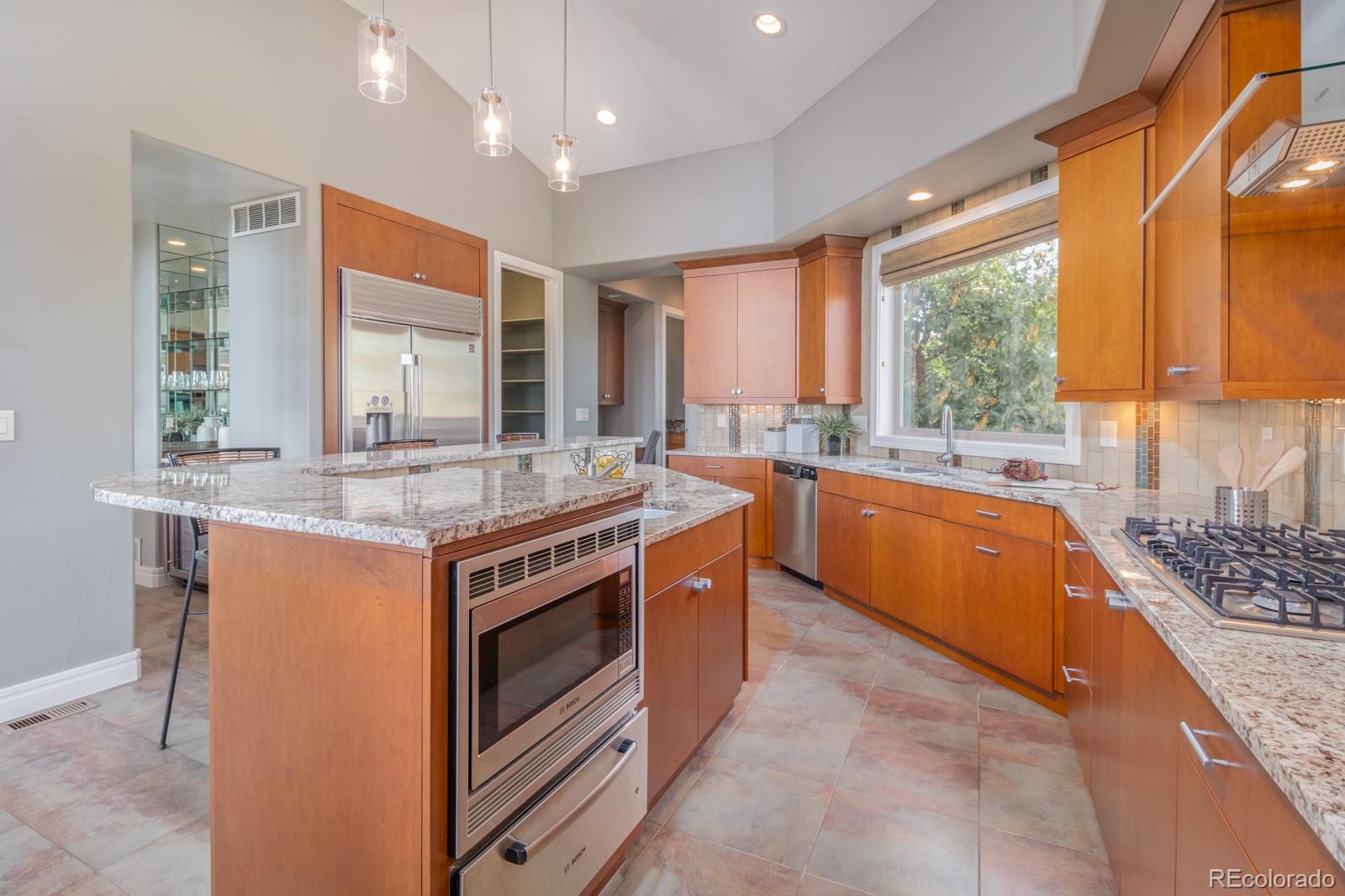 5241 Raintree Circle Parker, CO 80134 - Photo 11 of 36 a kitchen with stainless steel appliances granite countertop a stove a sink and a refrigerator