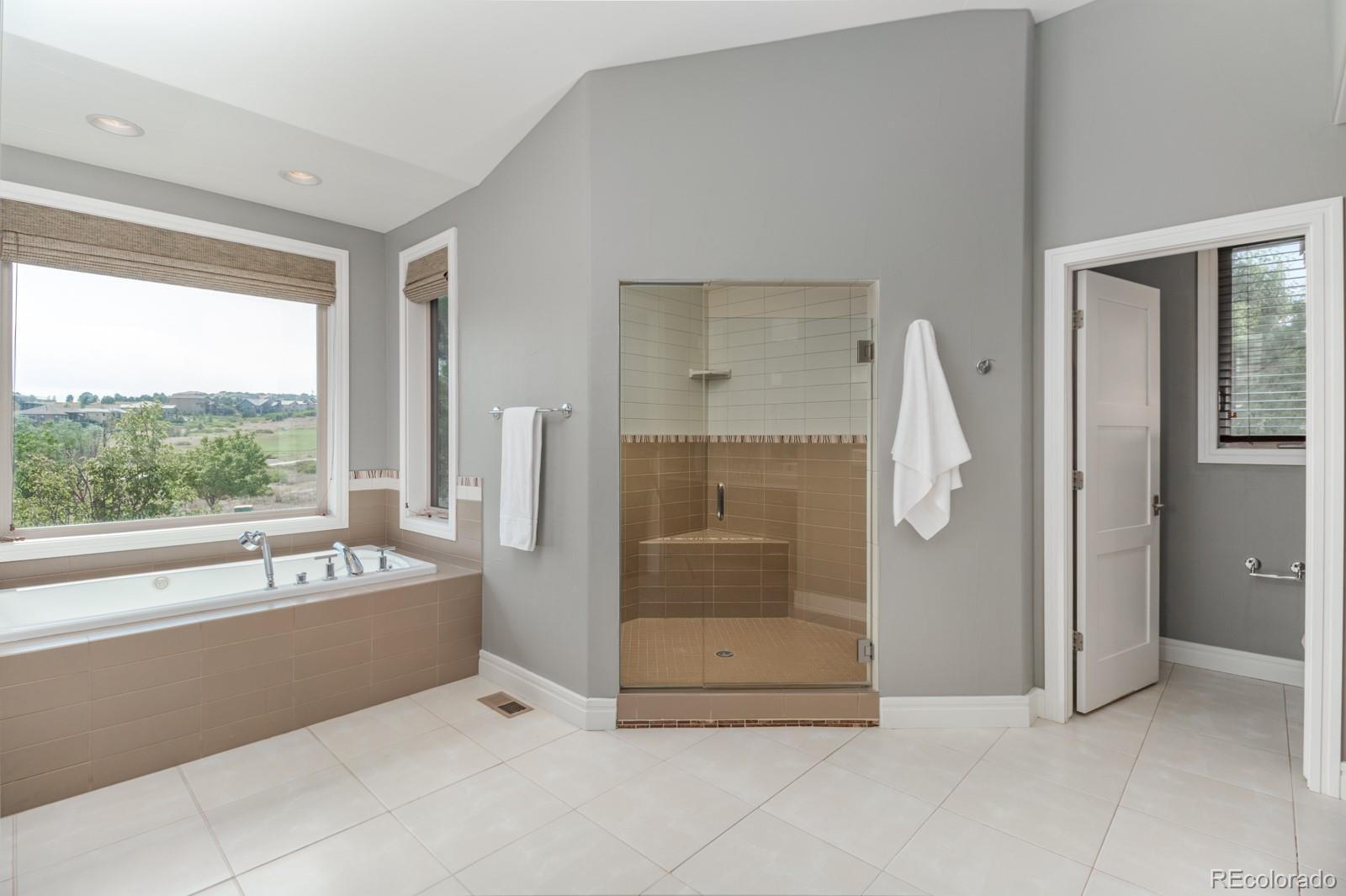 5241 Raintree Circle Parker, CO 80134 - Photo 18 of 36 a bathroom with a tub and a shower