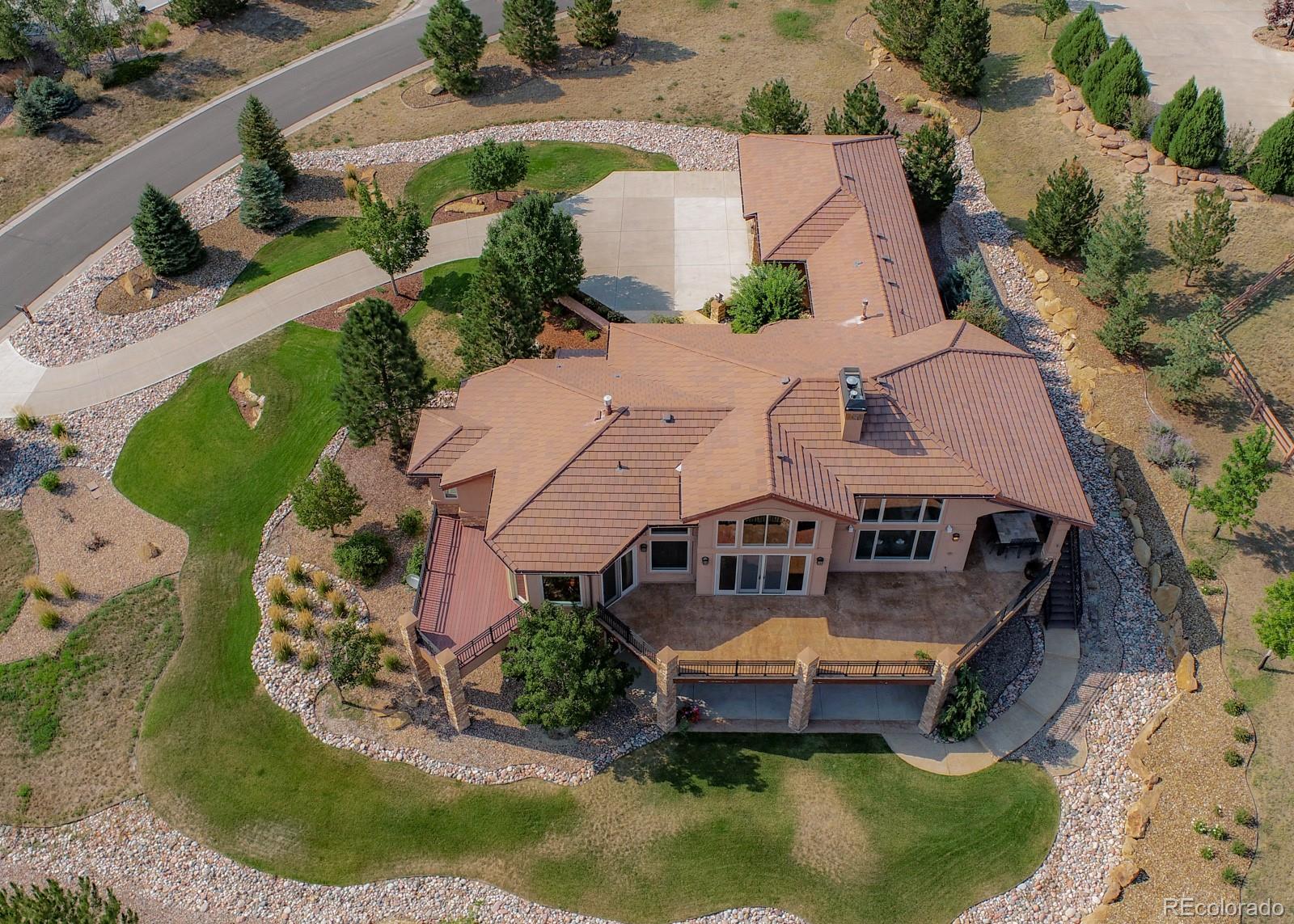 5241 Raintree Circle Parker, CO 80134 - Photo 2 of 36 an aerial view of a house with swimming pool and large trees