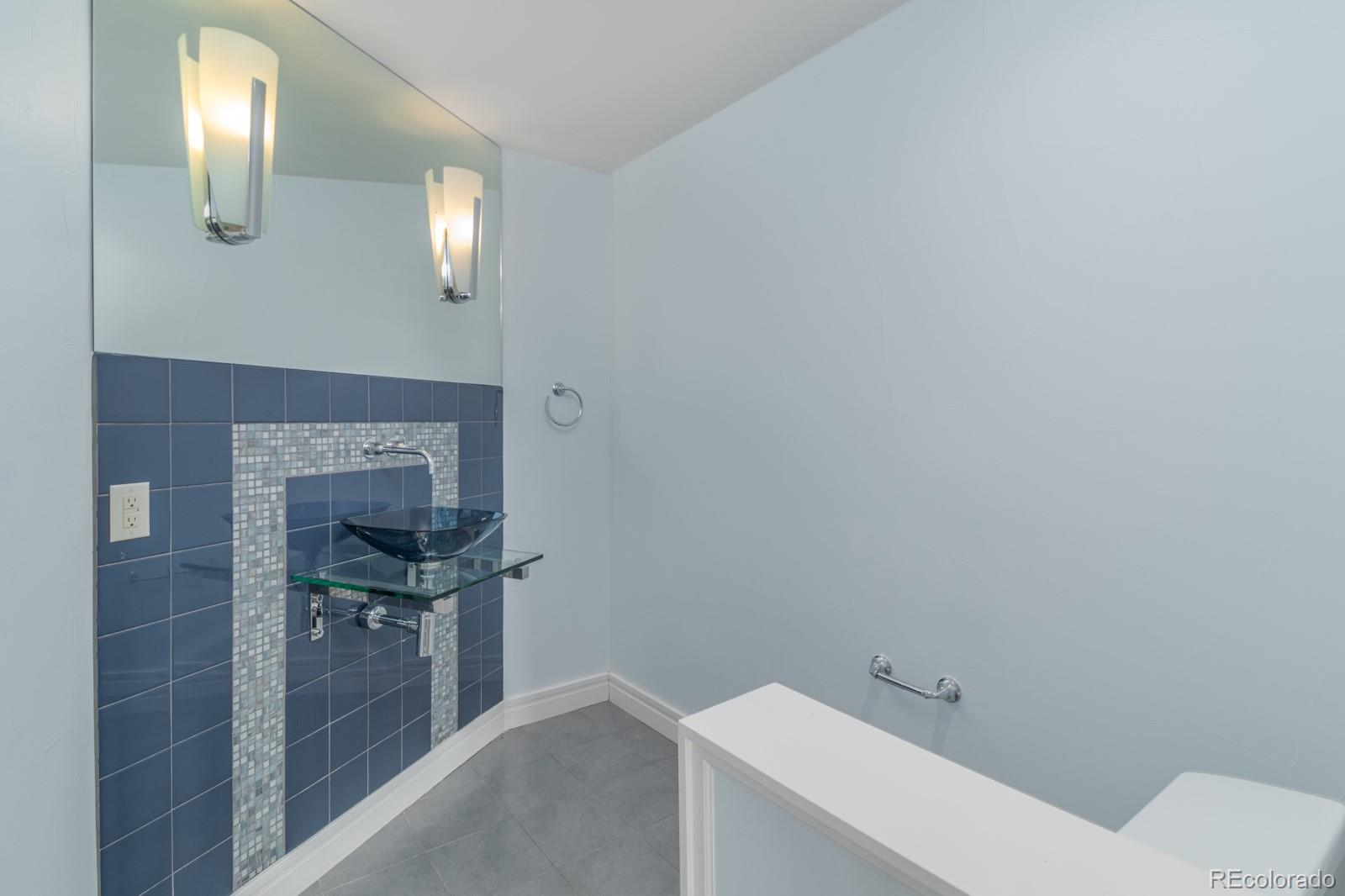 5241 Raintree Circle Parker, CO 80134 - Photo 23 of 36 a bathroom with a sink a toilet and mirror