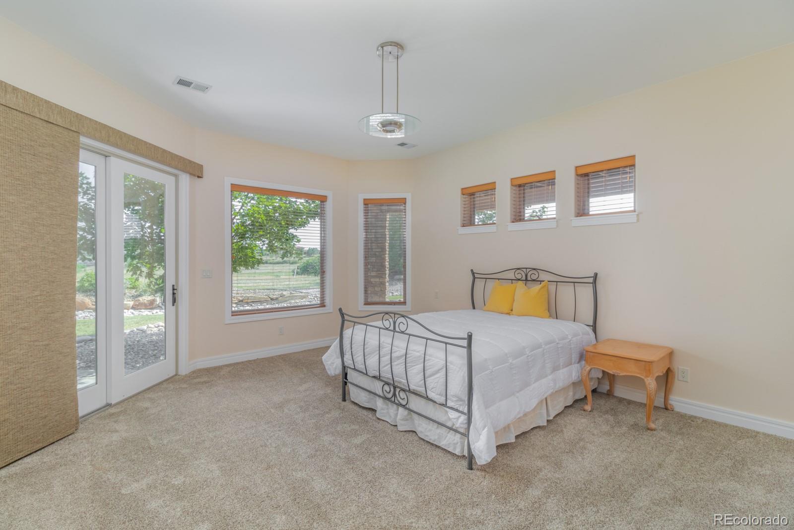 5241 Raintree Circle Parker, CO 80134 - Photo 24 of 36 a spacious bedroom with a bed and a window