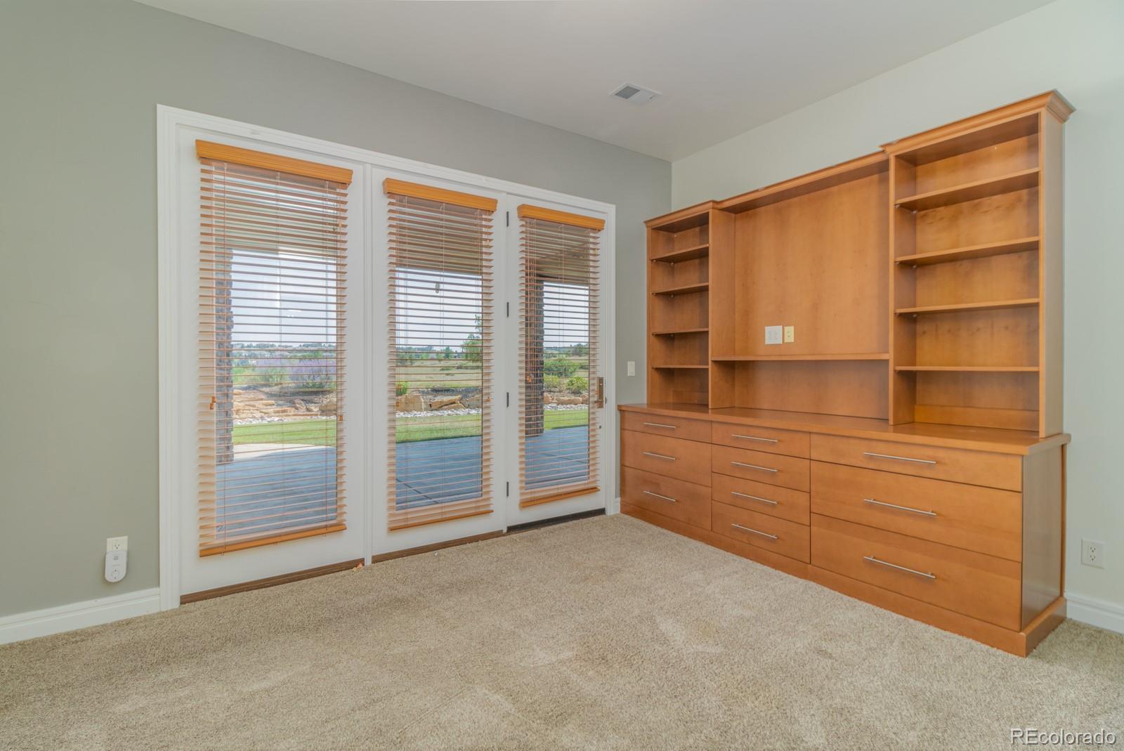 5241 Raintree Circle Parker, CO 80134 - Photo 26 of 36 a room with a dresser and a large window
