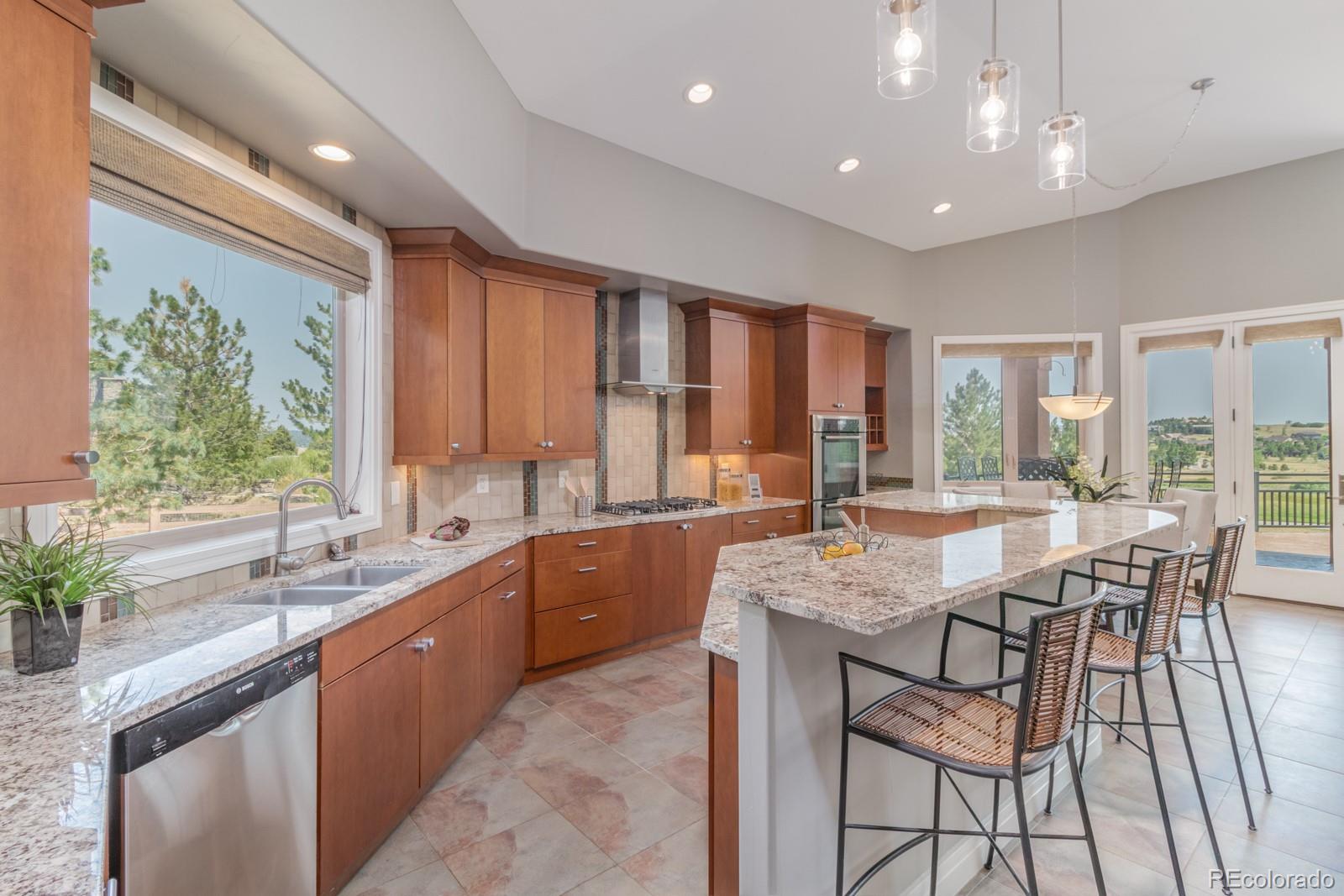 5241 Raintree Circle Parker, CO 80134 - Photo 10 of 36 a kitchen with granite countertop lots of counter top space and sink