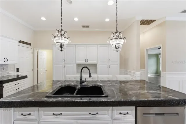 a kitchen with stainless steel appliances granite countertop a stove and a refrigerator