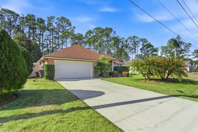an aerial view of a house with a garden and trees