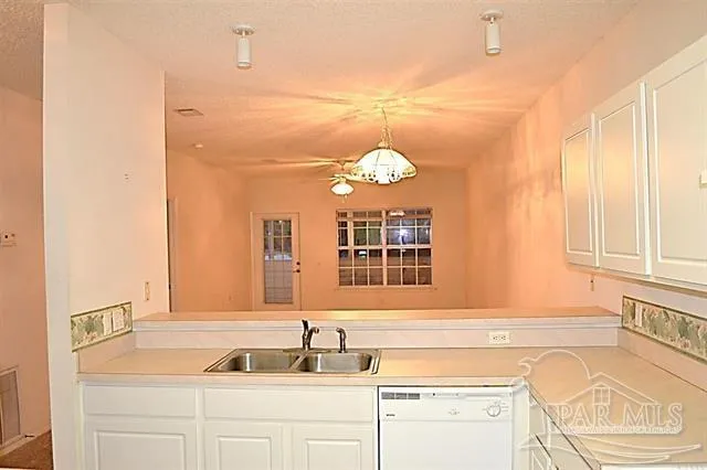 a kitchen with kitchen island a sink stove and refrigerator