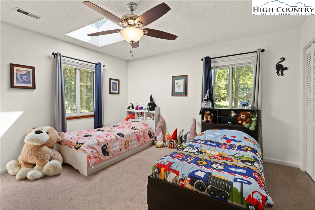 1848 Howard's Creek Road Boone, NC 28607 - Photo 36 of 49 a bedroom with two beds and a window