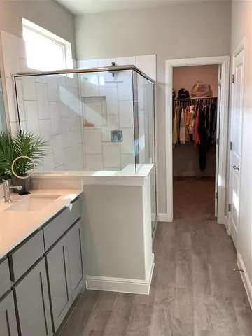 a bathroom with a shower and a sink