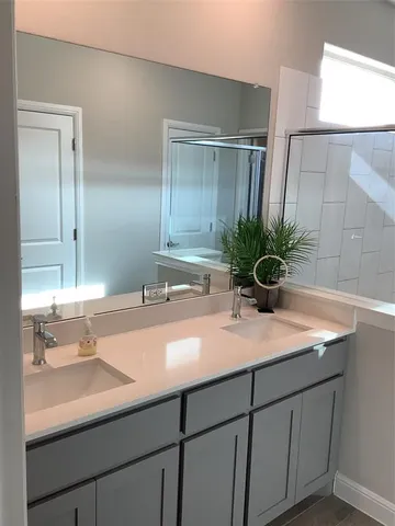 a bathroom with a sink a mirror and vanity