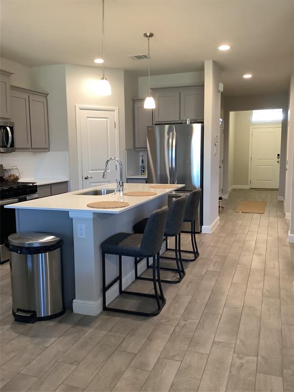 156 Hawksbill Lane Rhome, TX 76078 - Photo 8 of 19 a dining hall with stainless steel appliances granite countertop a stove a sink dishwasher and a refrigerator with wooden floor