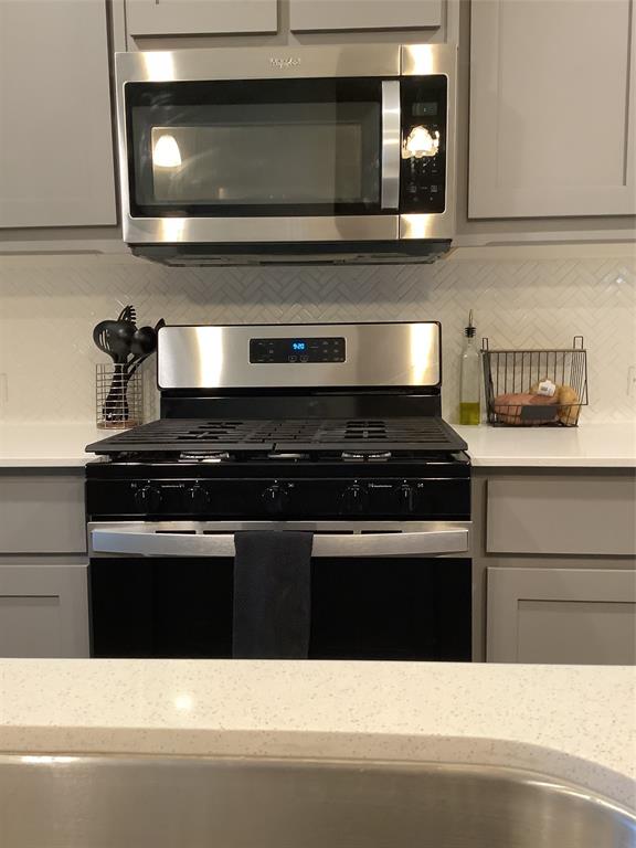156 Hawksbill Lane Rhome, TX 76078 - Photo 9 of 19 a kitchen with a stove and a microwave
