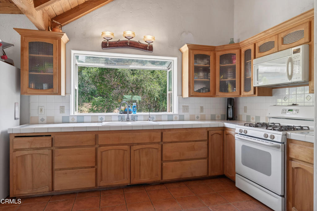 8416 Wheeler Canyon Road Santa Paula, CA 93060 - Photo 13 of 48 a kitchen that has a sink cabinets and window