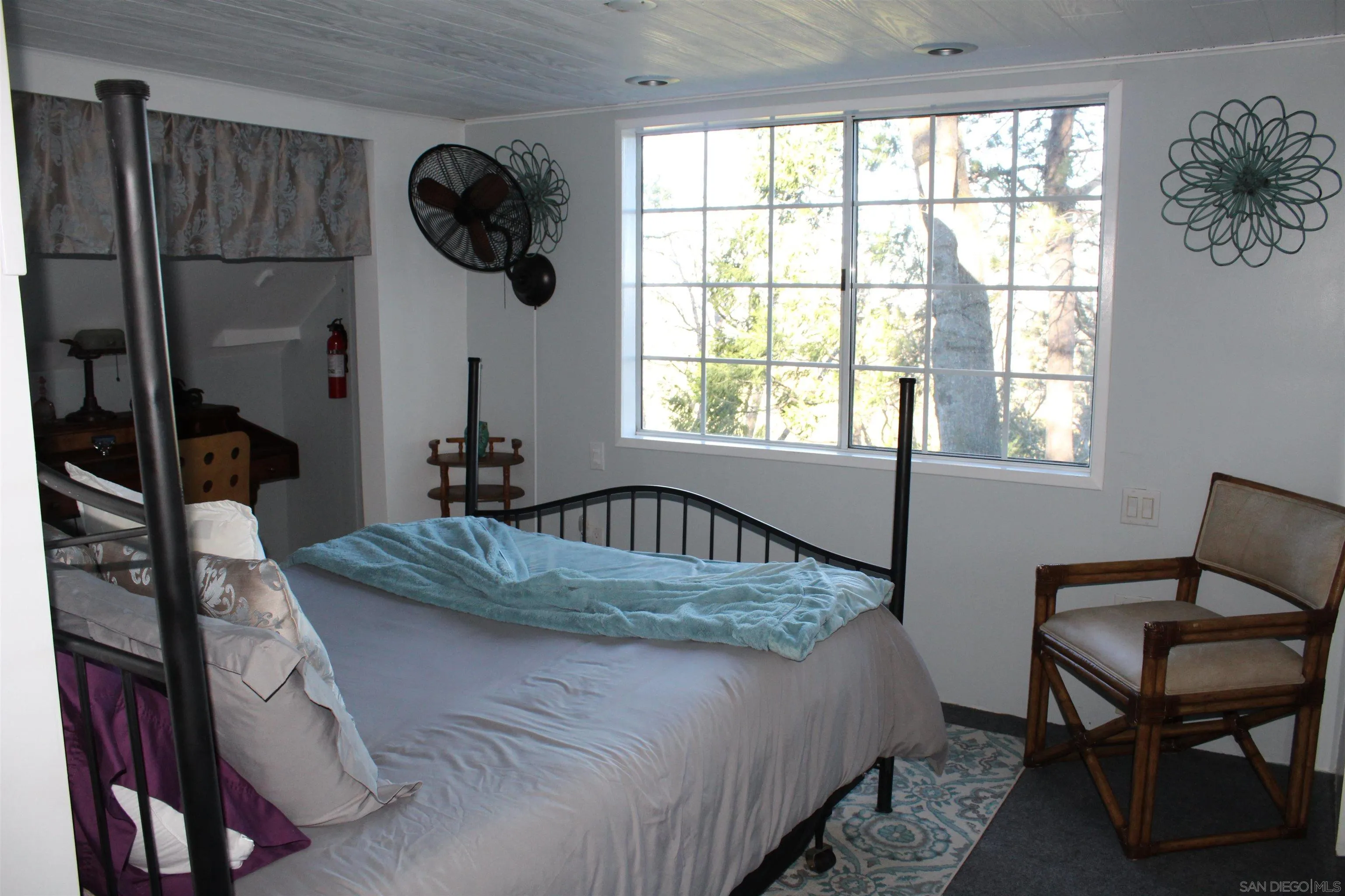 23984 Skyland Drive Crestline, CA 92325 - Photo 16 of 35 a bedroom with a bed a table and chair
