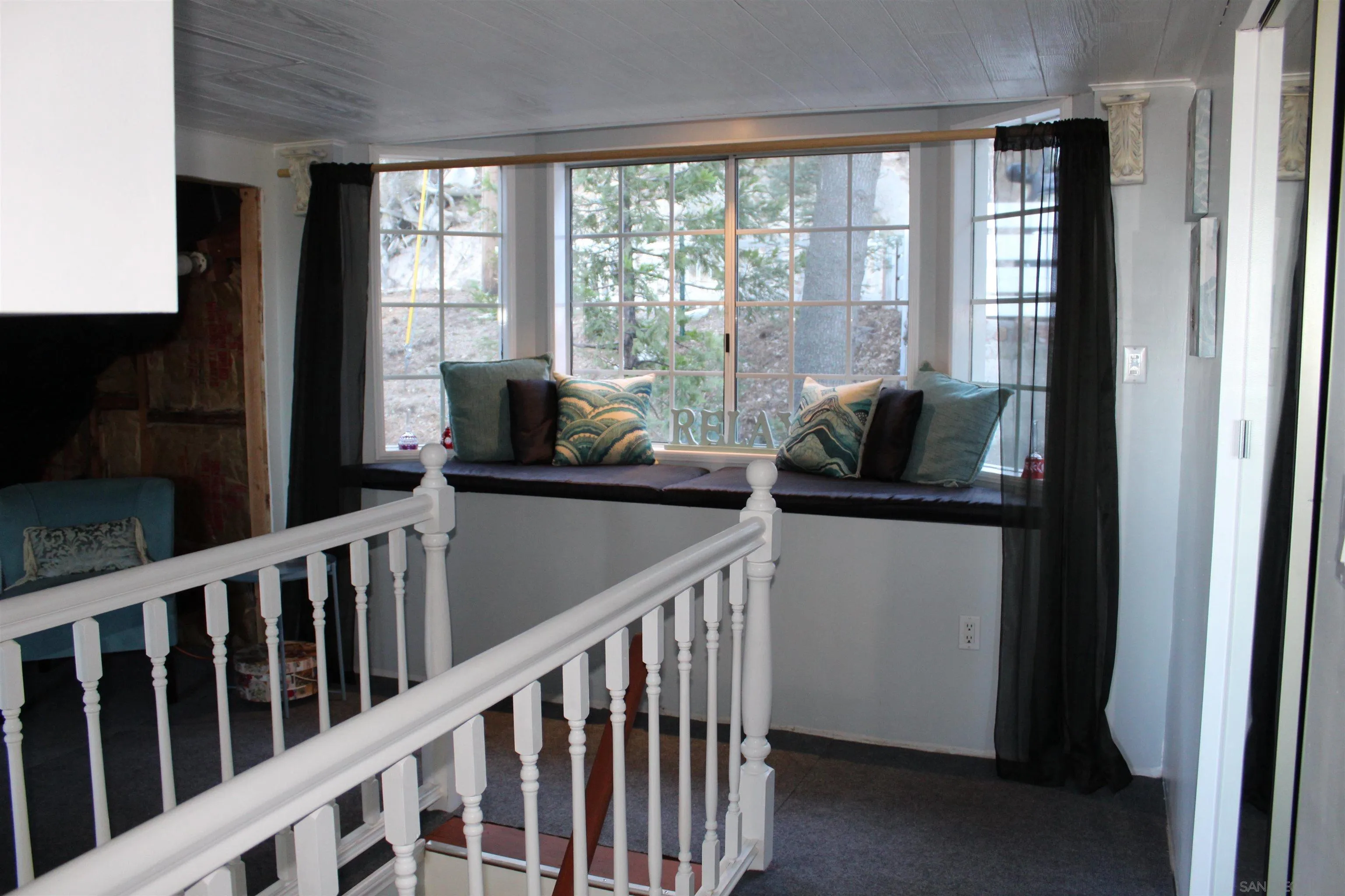 23984 Skyland Drive Crestline, CA 92325 - Photo 17 of 35 a living room with furniture and large windows
