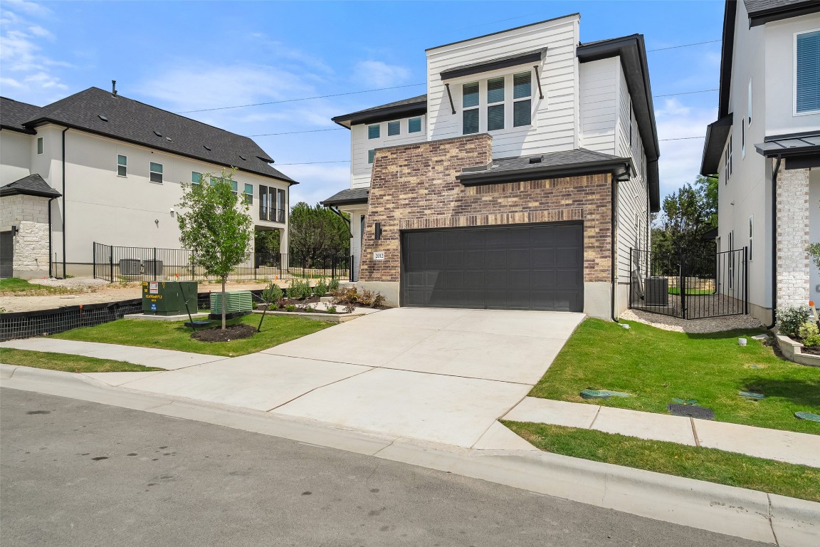 a view of a house with a yard and table and chairs